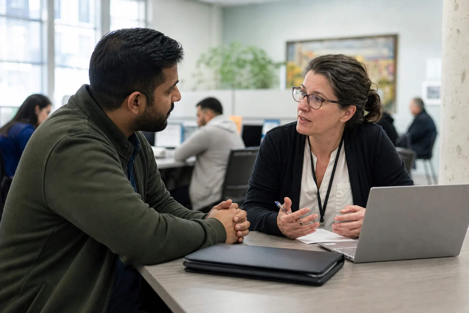 A newcomer discussing job-search strategy with a career adviser