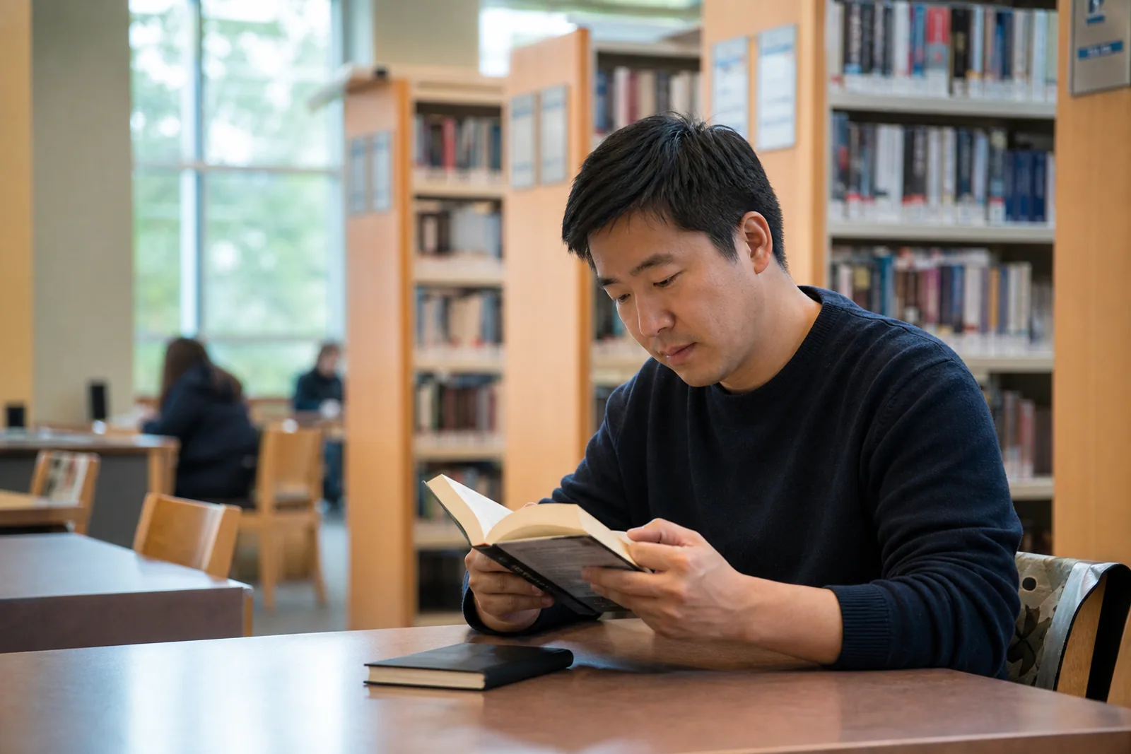 An adult studying quietly at a public library