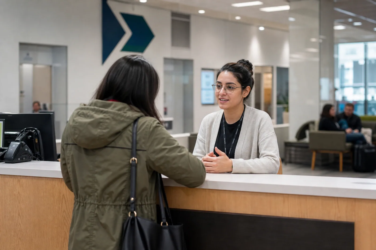 A newcomer speaking with staff at a public service centre
